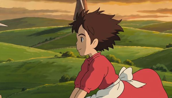 SeeDance 2.0 output for the prompt: Studio Ghibli style hand-drawn animation: a young girl flying on a broom over rolling green hills with windmills at sunset, hair blowing in the wind.
