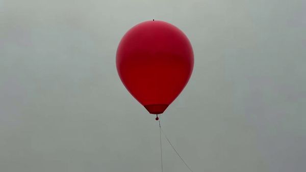 SeeDance 1.0 Lite output for the prompt: A single red balloon rises slowly against a plain overcast grey sky. Nothing else in the frame. 4 seconds.