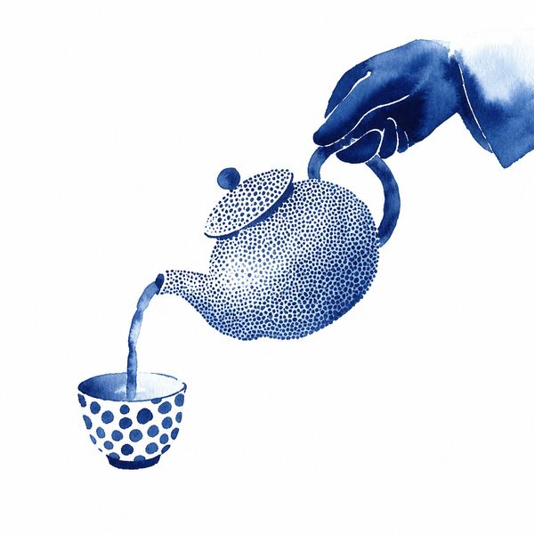 A hand pouring tea from a teapot into a small cup.