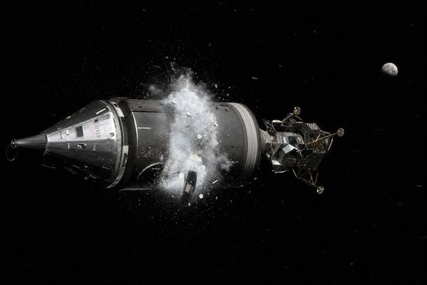 Realistic cinematic illustration, 1970 NASA film look. The Apollo 13 spacecraft (cone-shaped command module docked to the cylindrical silver service module, with the spider-like lunar module attached) in deep black space, halfway to the Moon; a panel on the side of the service module has just blown off and a violent white cloud of venting oxygen gas and debris sprays into space, glinting in harsh sunlight. The Moon small in the distance. Wide horizontal composition.