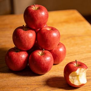 Seedream 4.5 output for the prompt: Exactly 7 red apples arranged in a pyramid on a wooden table, one apple with a bite taken out of it on the right side