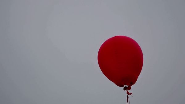 Kling 1.6 Pro output for the prompt: A single red balloon rises slowly against a plain overcast grey sky. Nothing else in the frame. 4 seconds.