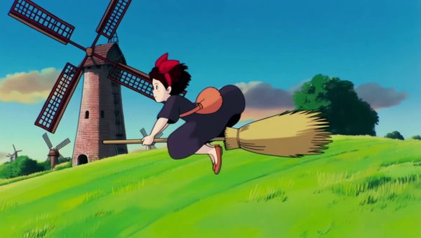 Luma Ray 2 output for the prompt: Studio Ghibli style hand-drawn animation: a young girl flying on a broom over rolling green hills with windmills at sunset, hair blowing in the wind.